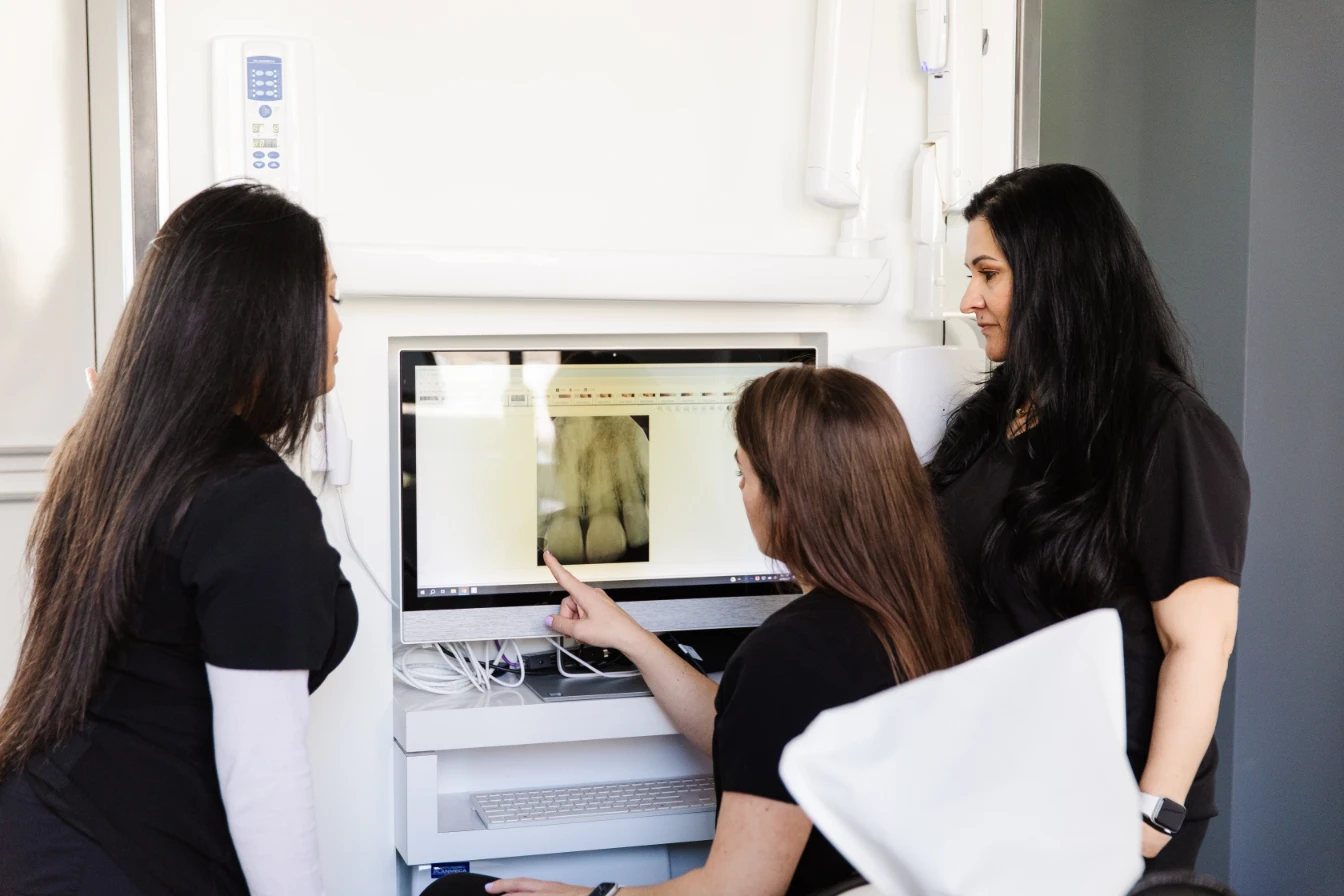 Looking at x-rays for dental implants in San Francisco.