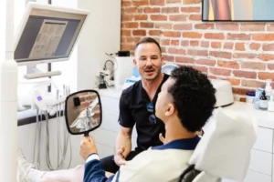 Cosmetic Dentist in San Francisco showing a patient his new smile at Dental Studio SF.