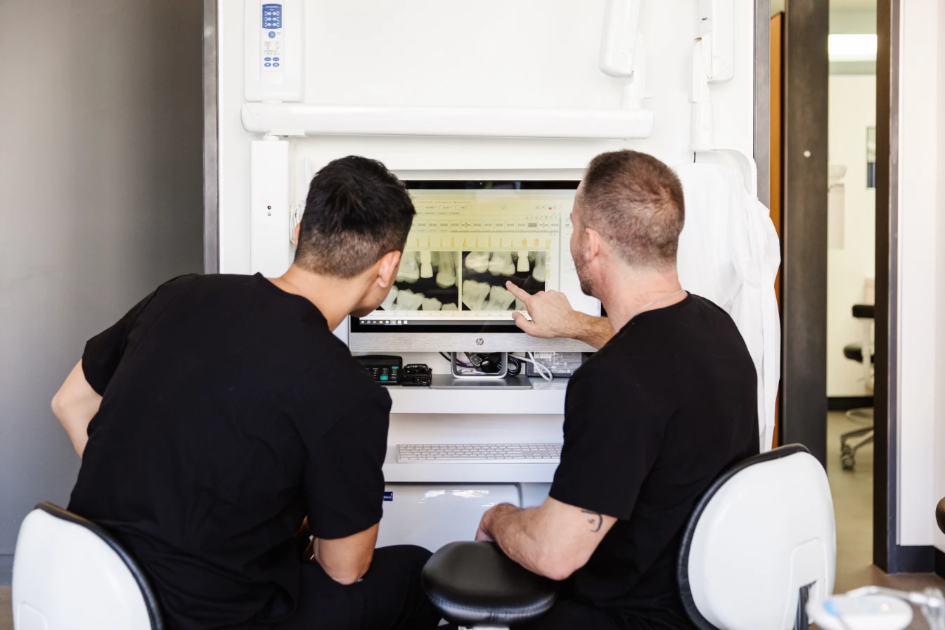 Dr. Cornehl and Dr. Ma looking at x-rays for dental implants in San Francisco.