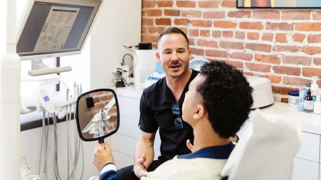 Cosmetic Dentist in San Francisco showing a patient his new smile at Dental Studio SF.